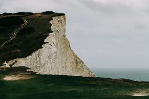 The iconic White Cliffs of Dover overlooking the English Channel on a cloudy day, captured from a scenic viewpoint. jigsaw puzzle