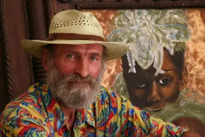 Bearded artist with hat posing in front of portrait painting in Marrakech. jigsaw puzzle