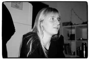 Monochrome portrait of a young woman with earrings in an indoor setting, captured candidly. jigsaw puzzle