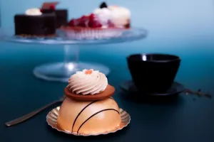 A close-up of a beautifully crafted French pastry with cream set against a stylish backdrop, perfect for dessert inspirations. jigsaw puzzle