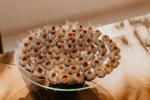 Delicate sweets beautifully arranged on a glass platter, perfect for event catering and dessert inspiration. jigsaw puzzle