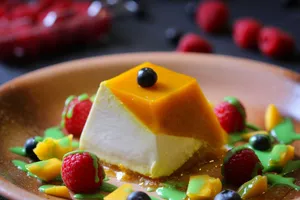 A delicious panna cotta topped with fresh fruits and vibrant sauces, perfect for dessert lovers. jigsaw puzzle