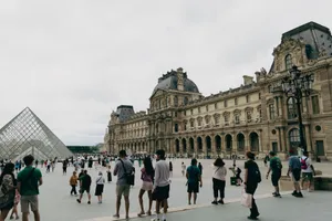 Visitors gather at the Louvre Museum in Paris with the iconic glass pyramid in view. jigsaw puzzle