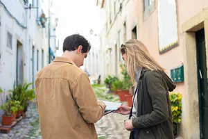 Two travelers exploring a charming European street, using a map for navigation. jigsaw puzzle