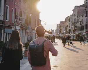 People strolling through a picturesque street in Venice at sunset, capturing the urban charm and timeless architecture. jigsaw puzzle