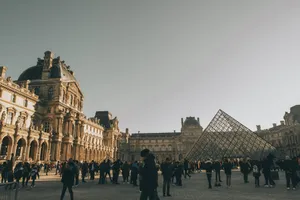 Tourists at the Louvre Museum with the iconic glass pyramid in Paris, France. jigsaw puzzle