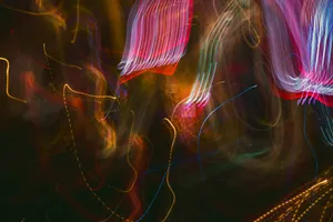 A dynamic and colorful abstract pattern created by blurred light trails. jigsaw puzzle