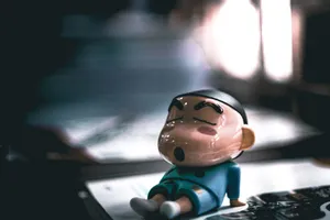 Close-up of a cartoon figurine sleeping on a table with soft lighting. jigsaw puzzle