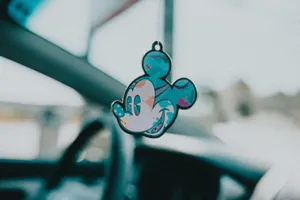Close-up of a vibrant Mickey Mouse keychain hanging inside a car for a whimsical touch. jigsaw puzzle