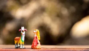 Playful miniature goat and whimsical character figurines on a rustic surface. jigsaw puzzle