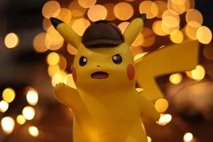 A close-up of a Pikachu figurine illuminated by a warm bokeh effect, creating an eye-catching visual. jigsaw puzzle