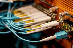 From above of optical switch equipment with many similar connectors with rubber cables and metal parts jigsaw puzzle