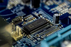 Detailed shot of a microprocessor on a blue motherboard showcasing electronic components. jigsaw puzzle