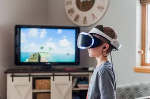 A young boy using a VR headset, fully engaged in a virtual reality experience indoors. jigsaw puzzle