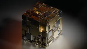 A gold and silver cube with intricate geometric patterns on a dark background. jigsaw puzzle