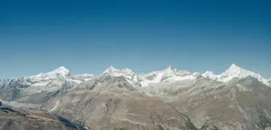 Stunning aerial view of the snow-capped Swiss Alps in Zermatt, capturing the majestic range under a clear blue sky. jigsaw puzzle