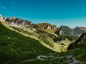 A panoramic view of the lush green Swiss Alps in Sennwald on a clear summer day. jigsaw puzzle