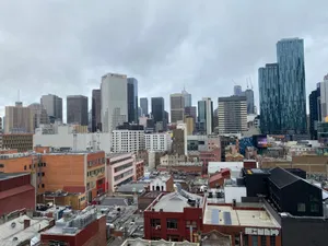 Aerial view of Melbourne's skyline under cloudy skies, showcasing modern architecture and urban life. jigsaw puzzle