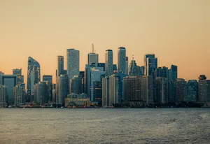 Toronto skyline with modern skyscrapers reflecting sunset light across Lake Ontario. jigsaw puzzle