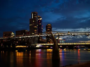 Twilight view of London's Millennium Bridge and skyline reflected on the Thames at night. jigsaw puzzle