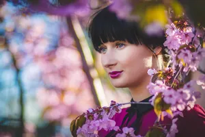 Close-up portrait of a woman surrounded by cherry blossoms showcasing spring beauty and fashion. jigsaw puzzle