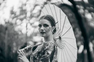 Fashion portrait of a woman in traditional attire holding a parasol in Mexico City. jigsaw puzzle