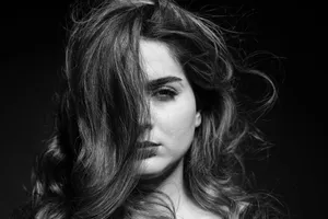 Artistic black and white portrait capturing an intense gaze with dynamic hair motion. jigsaw puzzle