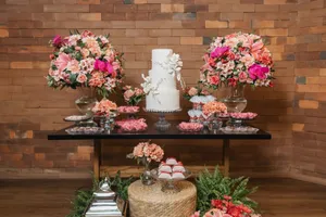 Luxurious wedding cake display with lush floral arrangements in a rustic setting. jigsaw puzzle