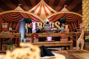 A lively circus-themed party table featuring cakes, decorations, and stuffed animals. jigsaw puzzle
