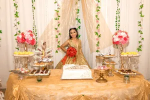 Quinceañera celebration featuring a girl in a golden dress with elegant table decorations and flowers. jigsaw puzzle