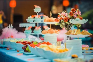 Colorful dessert table featuring a variety of fruits, cakes, and floral decor, ideal for celebrations. jigsaw puzzle