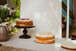 A selection of beautifully presented layer cakes on a table with natural lighting. Ideal for food photography and dessert enthusiasts. jigsaw puzzle