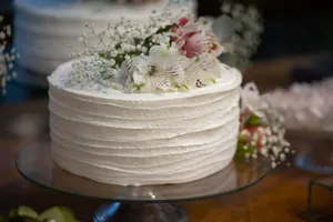 Beautiful white cake topped with flowers perfect for weddings and celebrations. jigsaw puzzle