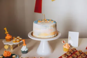A beautifully decorated cake with cupcakes for a first birthday celebration. jigsaw puzzle