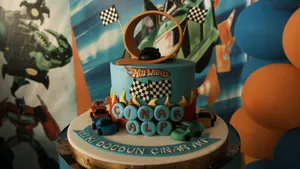Vibrant Hot Wheels birthday cake with toy cars and a loop track, perfect for a child's party. jigsaw puzzle