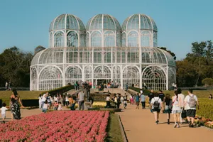 Captivating view of the glass conservatory and vibrant flowerbeds at Curitiba's botanical garden. jigsaw puzzle