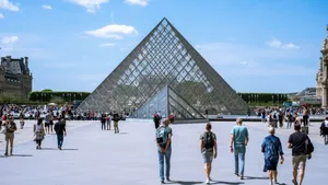 Visitors exploring the iconic glass pyramid of the Louvre Museum in Paris, France. jigsaw puzzle