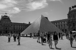 Monochrome photo of the Louvre Pyramid with visitors on a sunny day in Paris, France. jigsaw puzzle