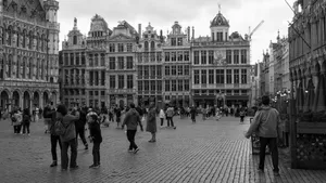 Black and white photo of Grand Place in Brussels with people strolling and historic architecture. jigsaw puzzle