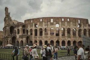 Tourists gather outside the historic Colosseum in Rome, capturing its majestic ancient architecture. jigsaw puzzle
