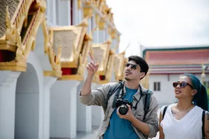 A couple of tourists admire intricate architecture, capturing moments with a Canon camera. jigsaw puzzle