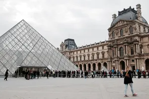 Visitors gather at the glass pyramid entrance of the Louvre Museum in Paris, capturing the blend of modern and classic architecture. jigsaw puzzle
