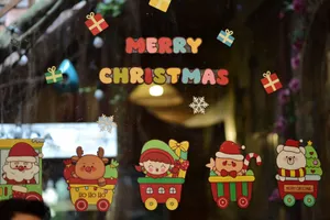 Colorful Christmas decorations on a window, featuring festive characters and holiday cheer. jigsaw puzzle