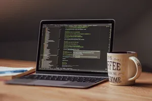 Laptop displaying code editor with coffee mug on desk, perfect for tech themes. jigsaw puzzle