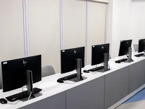 Minimalist open office space featuring empty computer desks with monitors. jigsaw puzzle