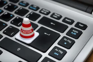 Miniature caution cone on a computer keyboard symbolizing data security and control. jigsaw puzzle