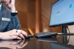Close-up of a business professional using a computer mouse and keyboard in a modern office environment. jigsaw puzzle