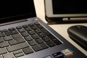 Close-up of laptop keyboard, wireless mouse, and tablet illustrating modern workspace technology. jigsaw puzzle
