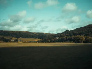 Beautiful rural landscape in Llanfair Talhaiarn, Wales with rolling hills, trees, and a bright summer sky. jigsaw puzzle
