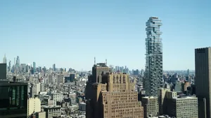Captivating view of New York City skyline featuring iconic skyscrapers and clear blue sky. jigsaw puzzle